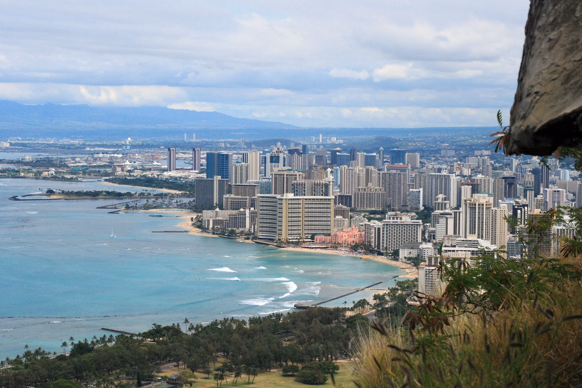 Waikīkī and Honolulu seen from high on Diamond Head, with the crater wall at the right edge