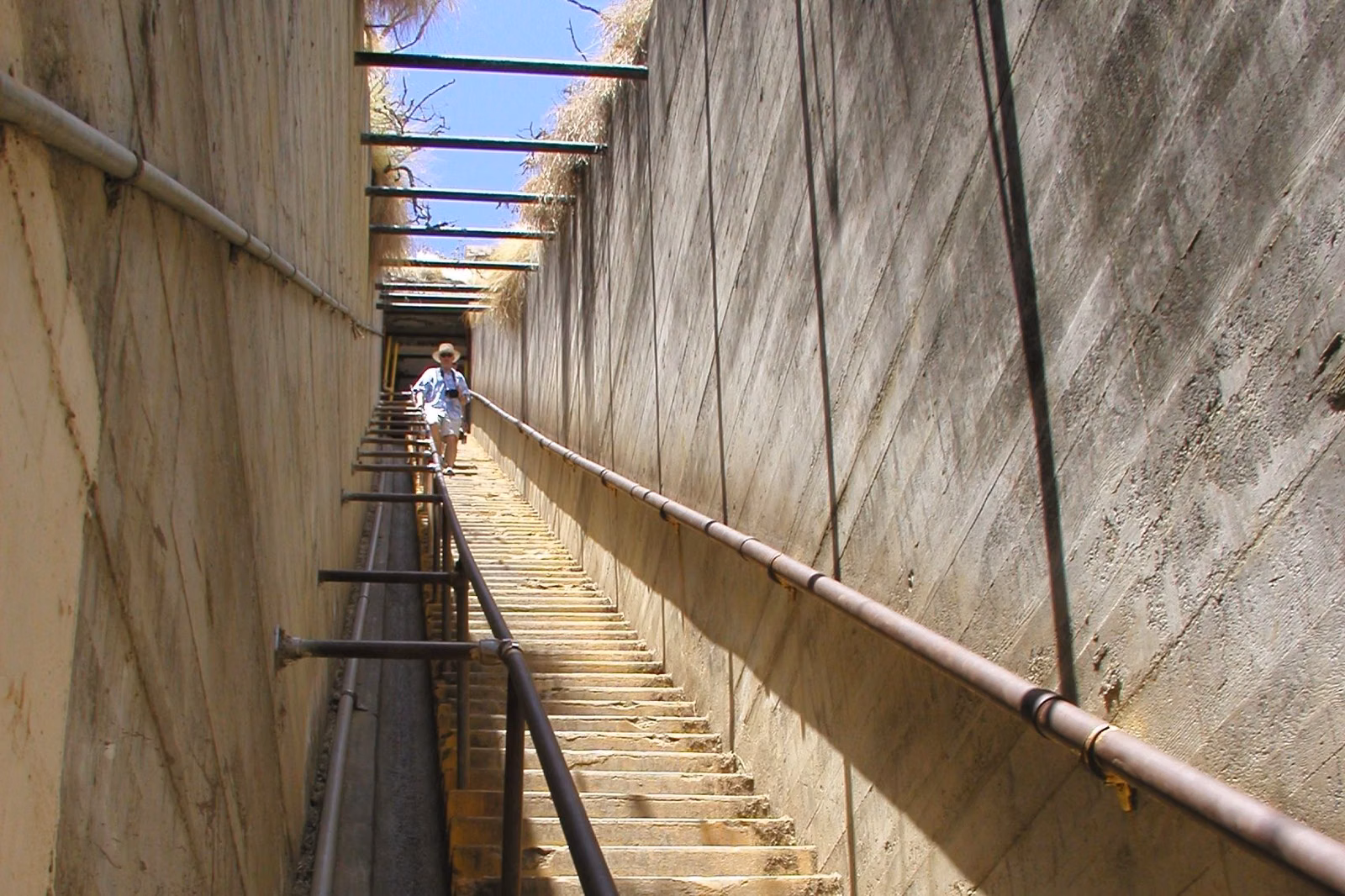 The long, steep concrete stairway on the Diamond Head summit trail, with a handrail and overhead beams