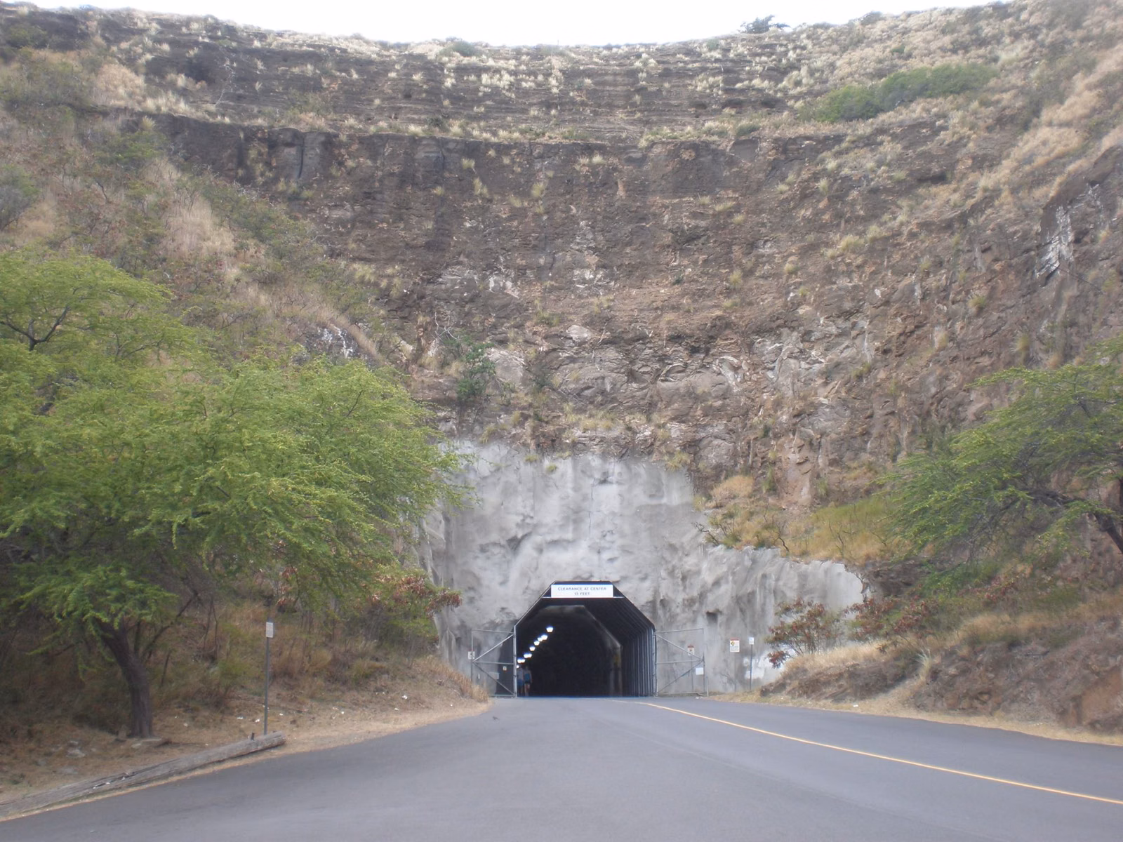 The road tunnel through the wall of Diamond Head crater, with the steep tuff cliff above it
